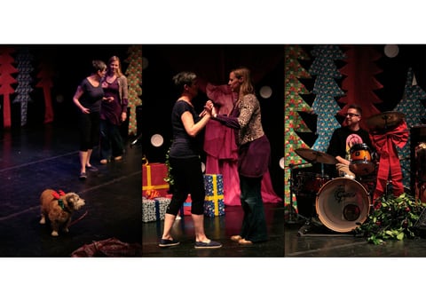A three-part sequence on a stage of cardboard Christmas trees — two women beside a terrier in antlers, the pair clasping hands in a dance, and a bearded man playing a drum kit.